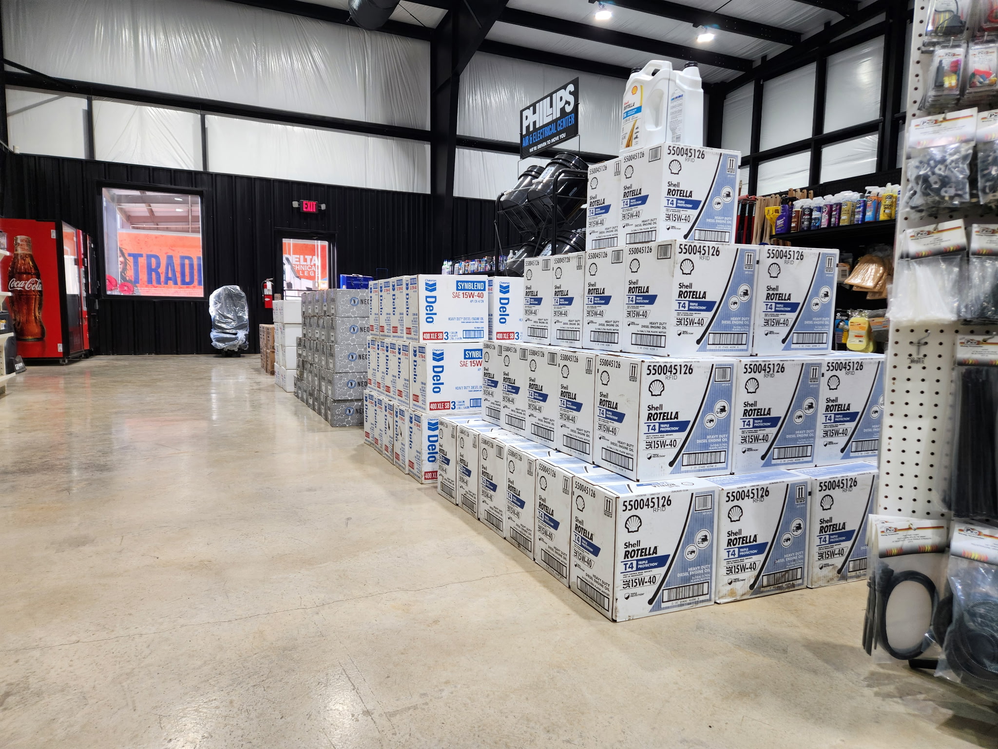 Stacks of Shell Rotella diesel oil boxes and maintenance supplies at Wilkerson's parts counter